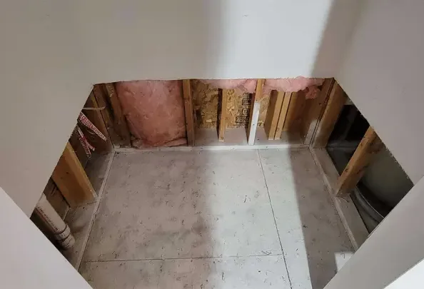 Lower wall sections removed to expose framing around a bare floor